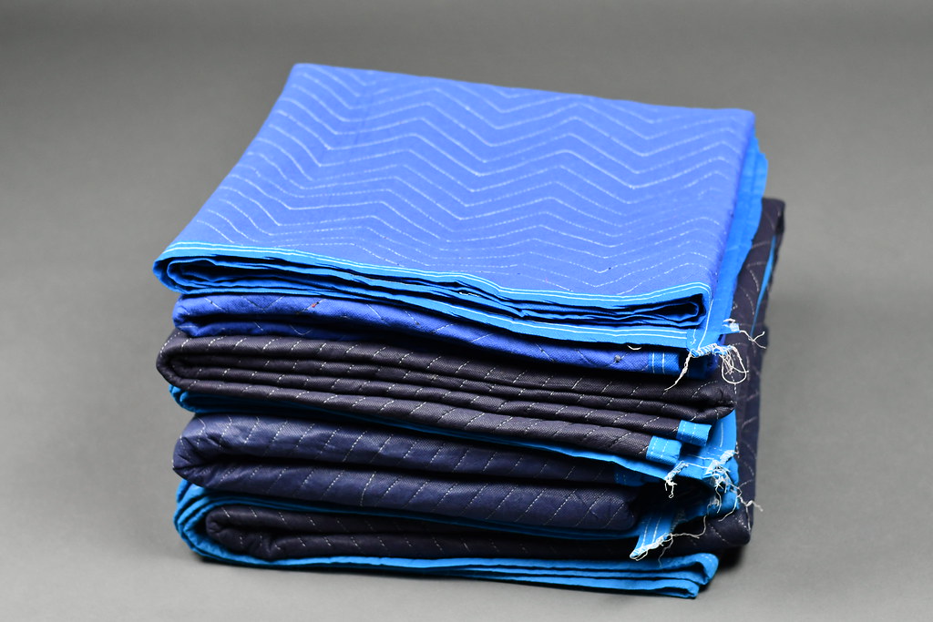 A Pile of Black and Blue Moving Blankets by hireahelper, on Flickr